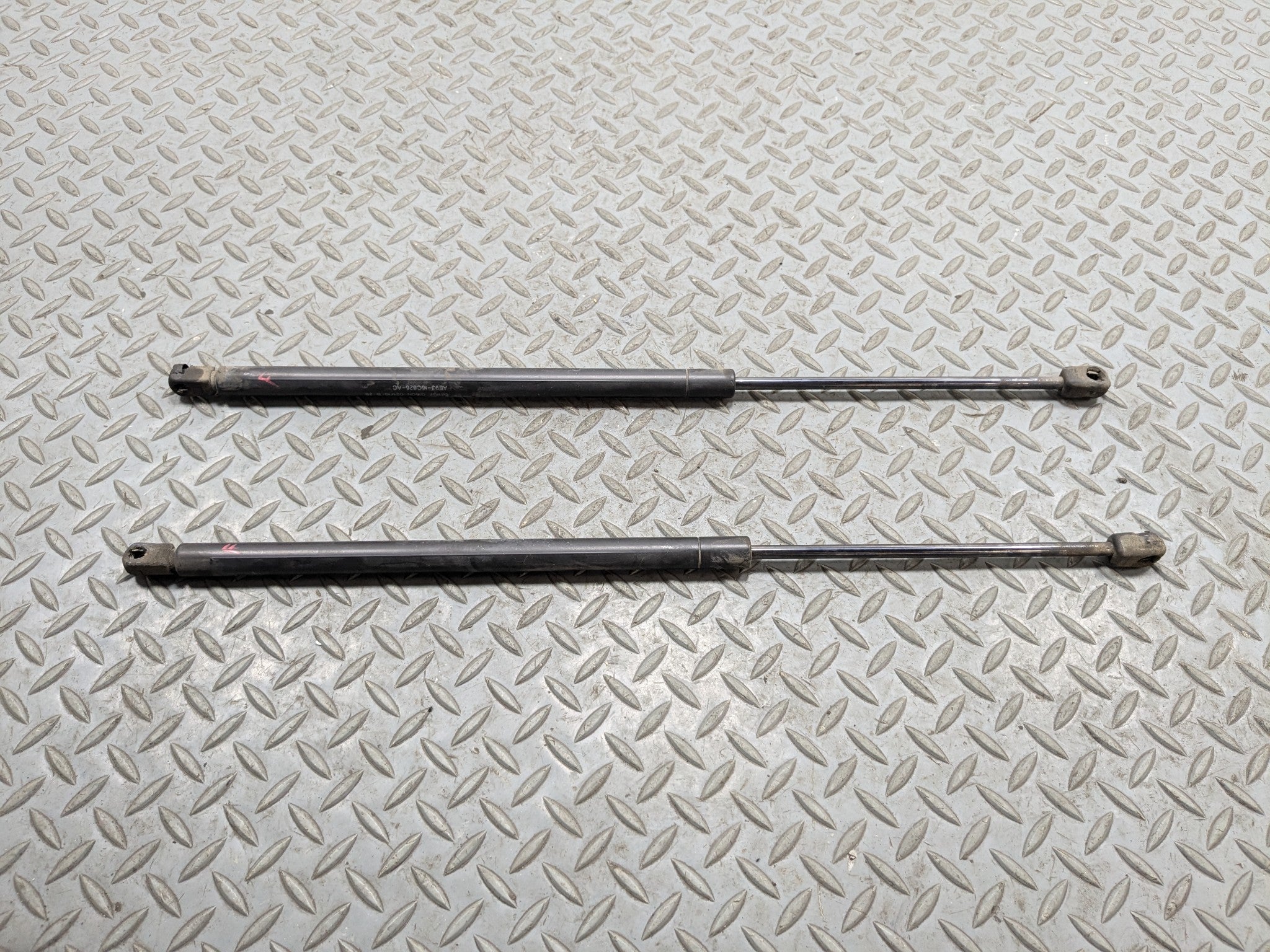 10 - 15 LINCOLN MKT OEM HOOD SHOCK STRUT SET OF TWO FRONT LEFT AND RIGHT SIDE